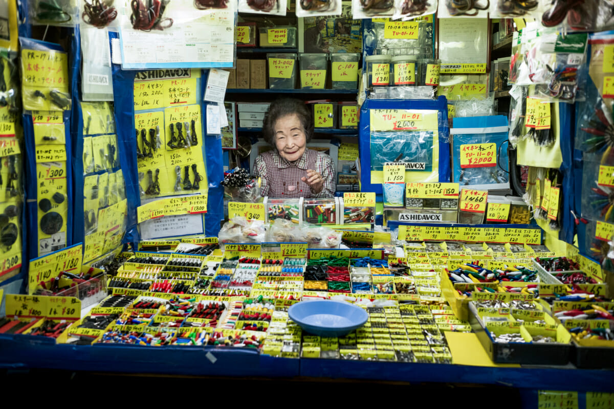a smiling old Japanese lady in her very little tokyo shop