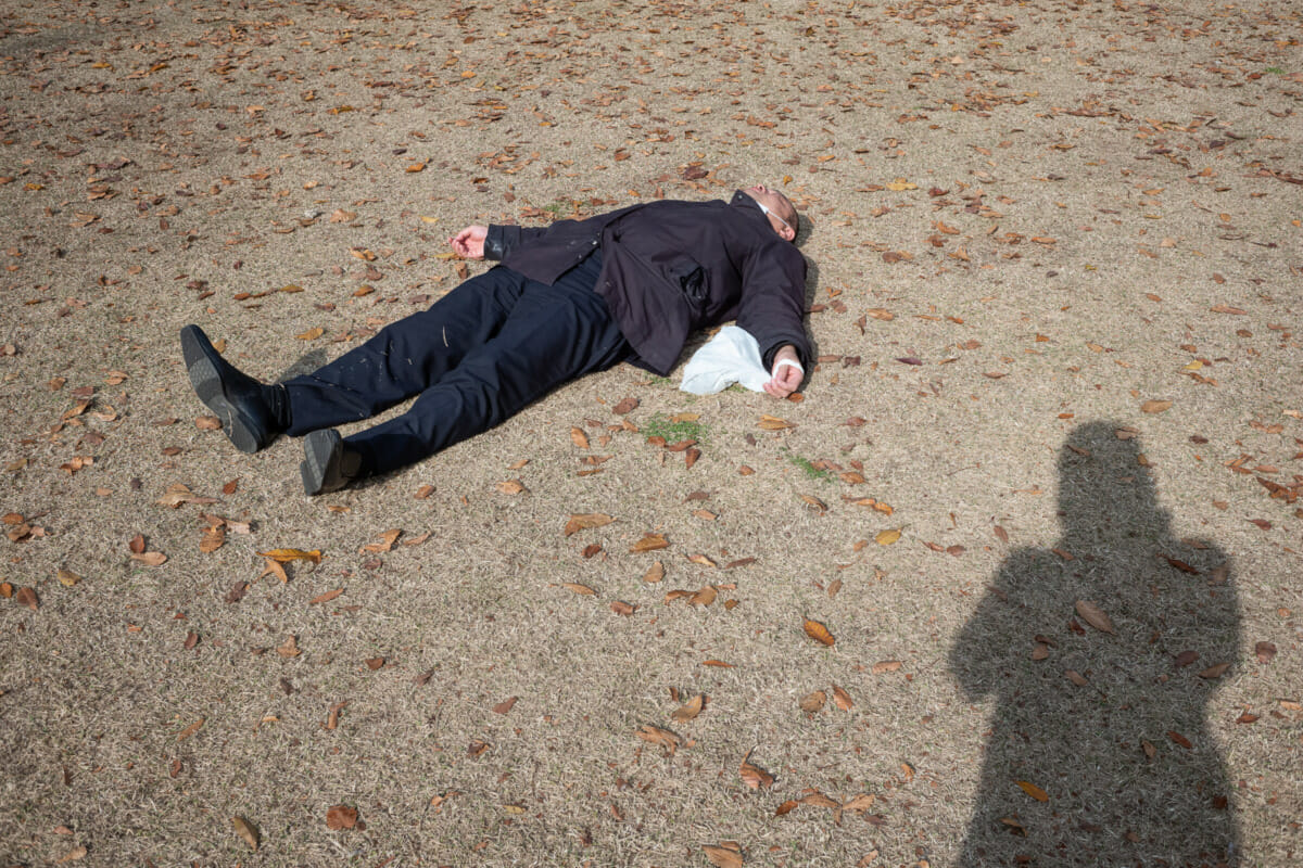 sprawled out and asleep tokyo salaryman