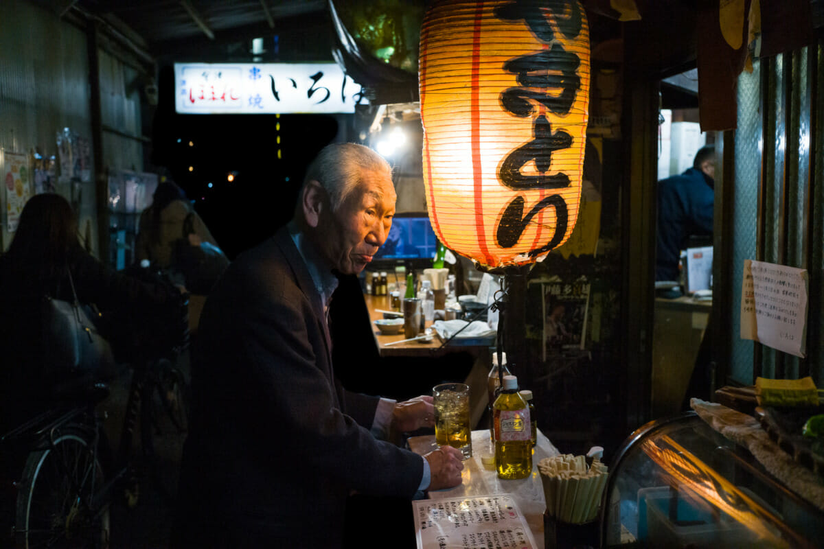 Japanese alleyway drinks, a lantern and an illuminated face