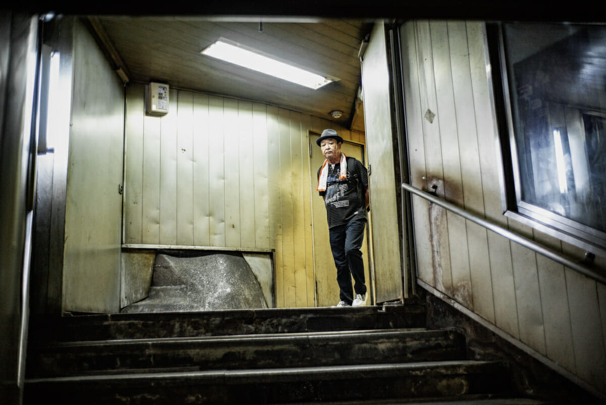 An old man in an old and retro Tokyo subway entrance