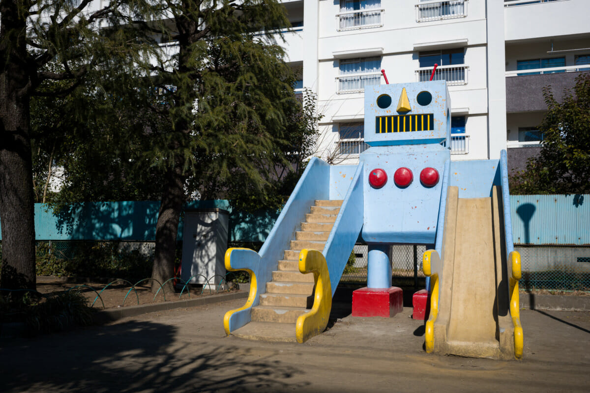 A large and retro concrete robot in an urban Tokyo park