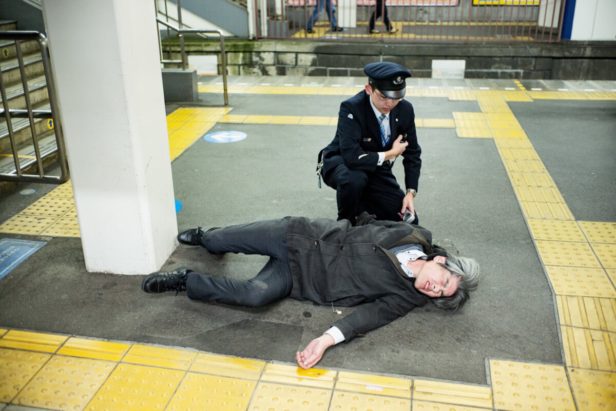 Japanese man drunk at a tokyo train station