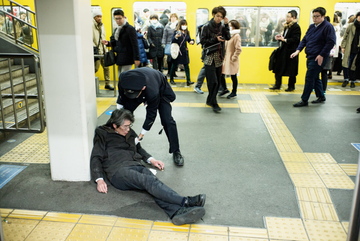 japanese man drunk at a tokyo train station