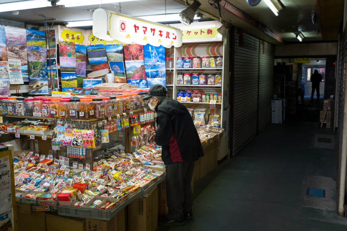 traditional little Japanese sweet shop in a dark Tokyo alleyway